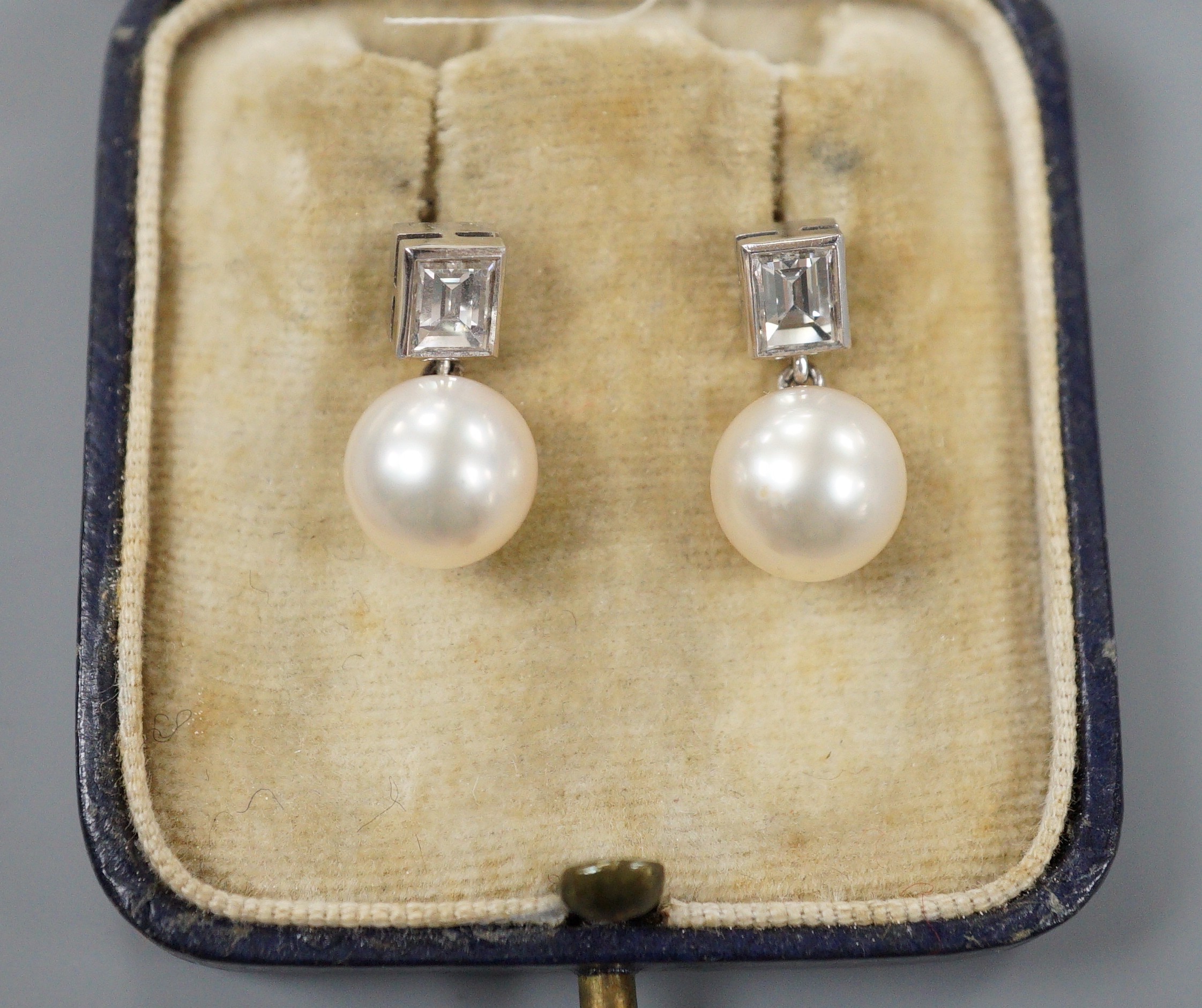 A pair of 18ct white metal, cultured pearl and diamond set drop earrings, 17mm, gross weight 4.3 grams.